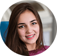 Teenage girl with braces sitting in orthodontic treatment chair